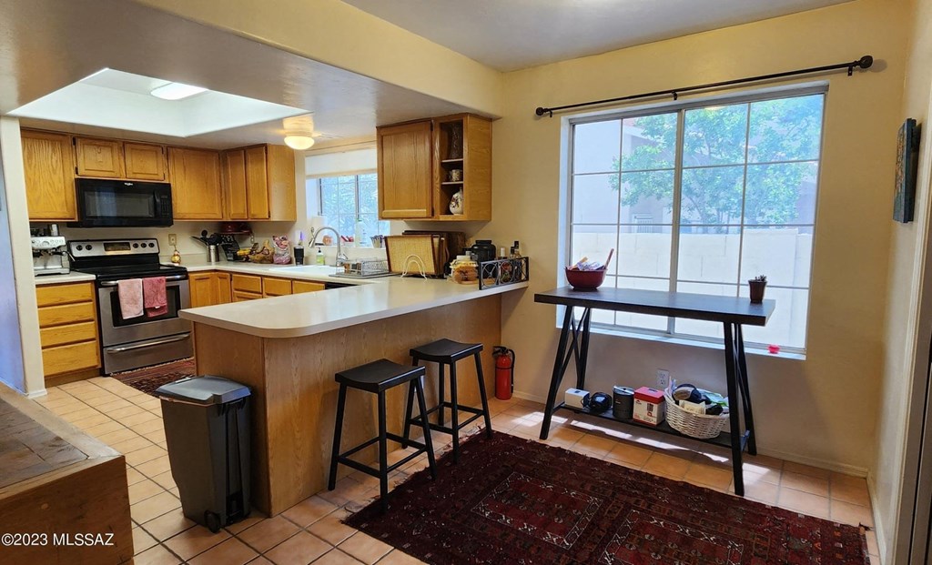 a kitchen with a bar and a large window