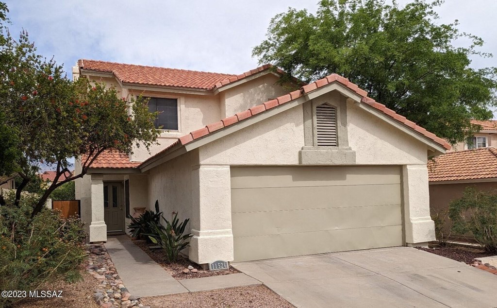 a house with a driveway and a garage door