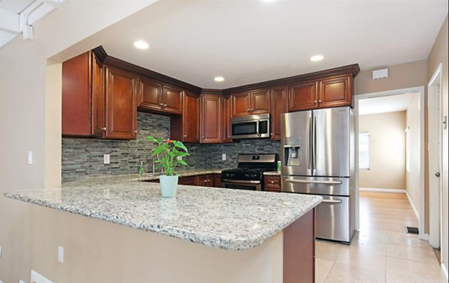 a kitchen with granite counter top and stainless steel appliances