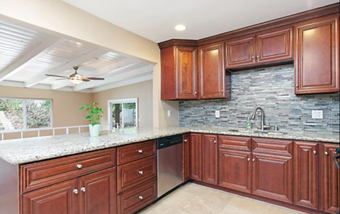 a kitchen with wooden cabinets and a granite counter top