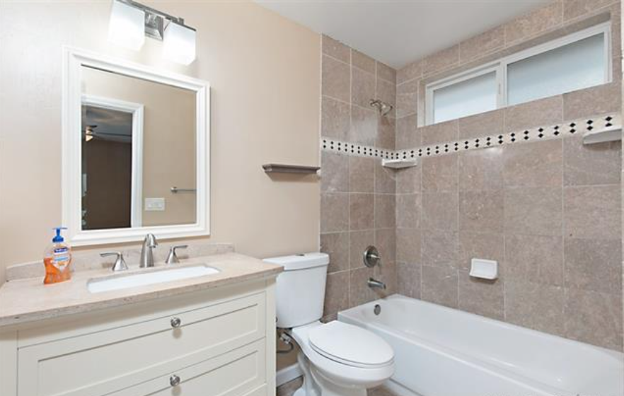 a bathroom with a sink toilet and a bath tub