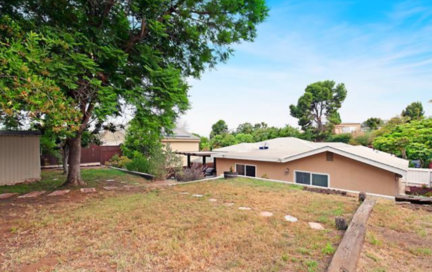 a house with a yard and a tree