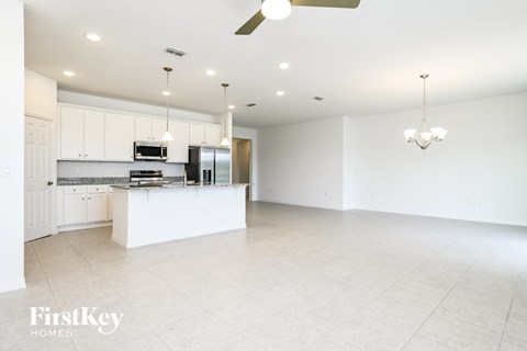 A spacious kitchen with white cabinets and a large island.