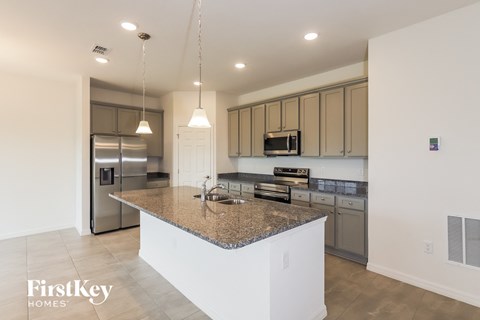 a large kitchen with granite counter tops and stainless steel appliances