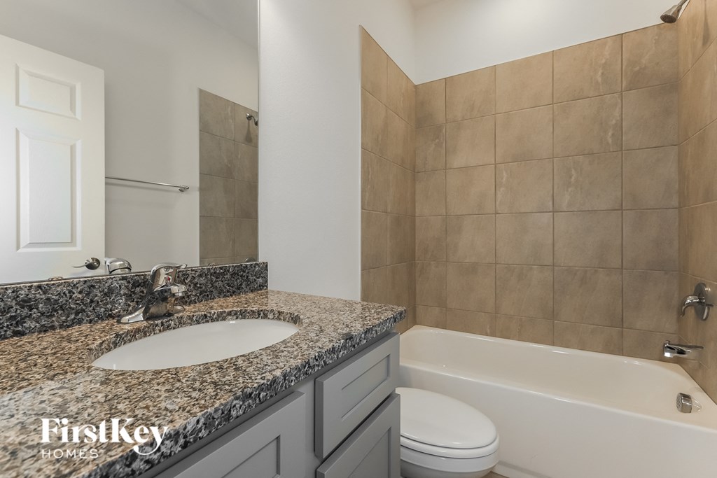 a bathroom with a sink and a tub and a toilet