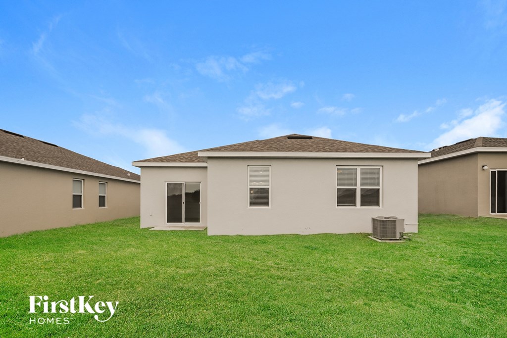 a home with a green lawn and a house next to it