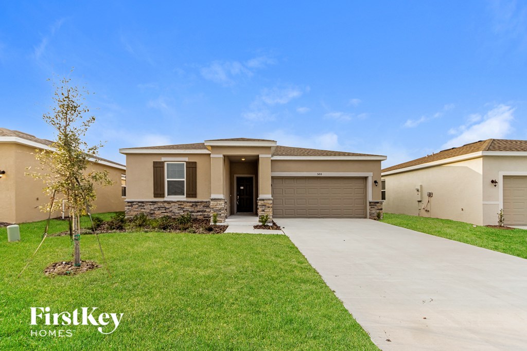 A house with a tree in front of it is for sale by FirstKey Homes.