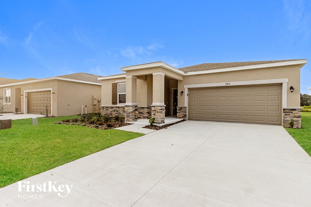 A house with a garage and a driveway is for sale.