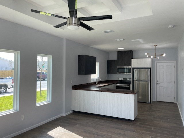 an empty kitchen with a ceiling fan