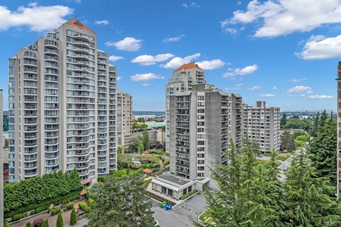 A view of a residential area with multiple apartment buildings and a parking lot.