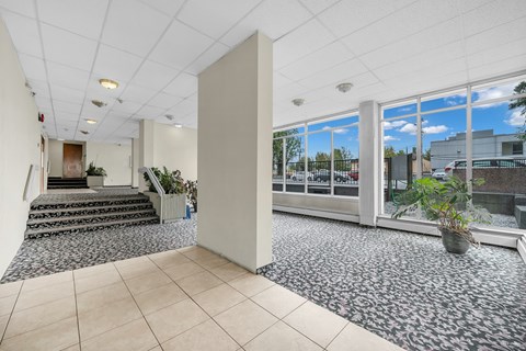 A spacious office with a view of the outdoors through large windows.