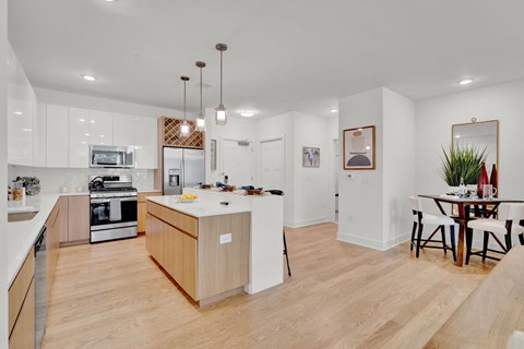 a kitchen with an island and a dining table
