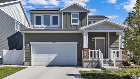 A two-story house with a garage and a front porch.