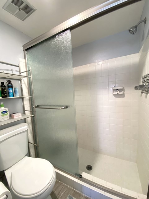 a small bathroom with a shower and a toilet