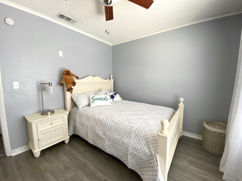 a bedroom with a bed and a teddy bear