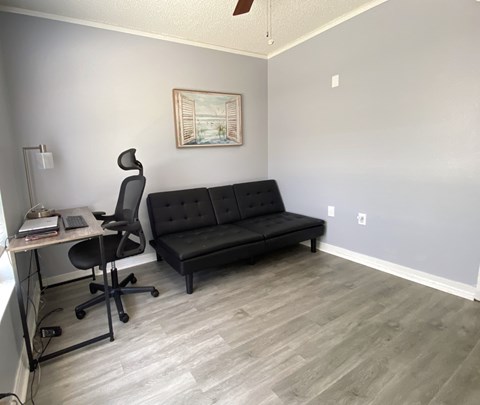 an office with a couch and a desk and a chair