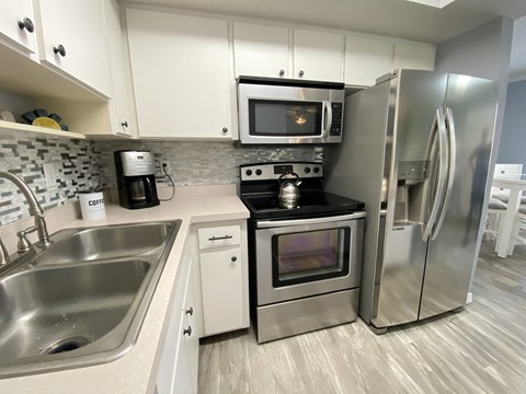 a kitchen with stainless steel appliances and a sink