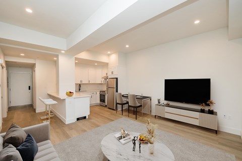 A modern living room with a grey sofa and a grey coffee table.