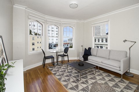 A living room with a white couch and a coffee table.