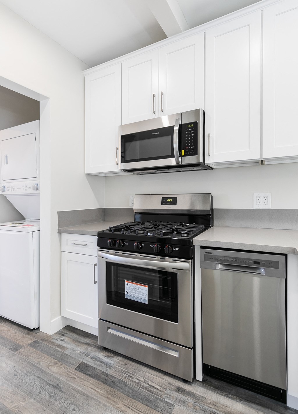 a kitchen with stainless steel appliances and white cabinets