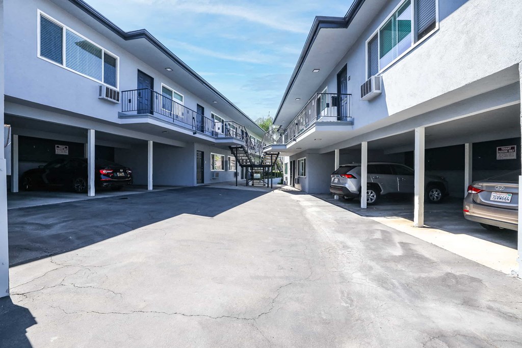 a parking lot with cars parked in front of a building