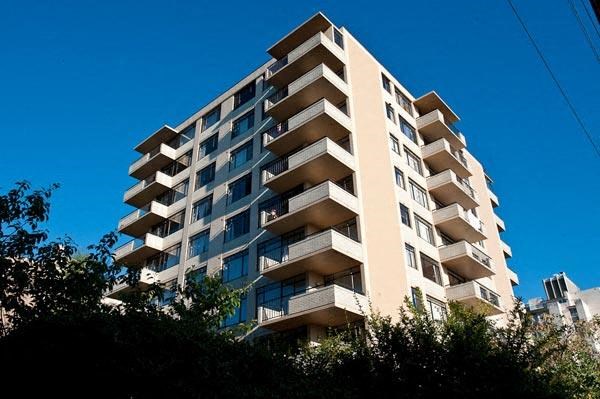 A tall building with balconies on each floor.