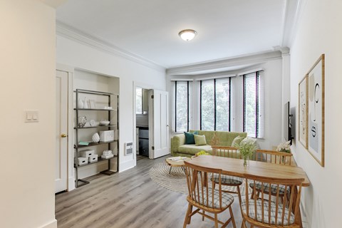 a living room and dining room with a table and chairs