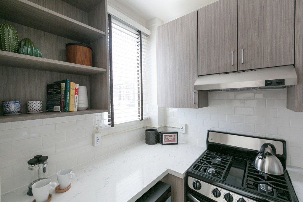 a small kitchen with a stove and a window