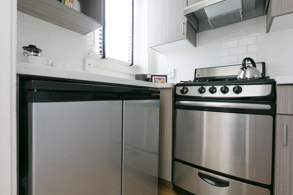 a small kitchen with a stove and a refrigerator