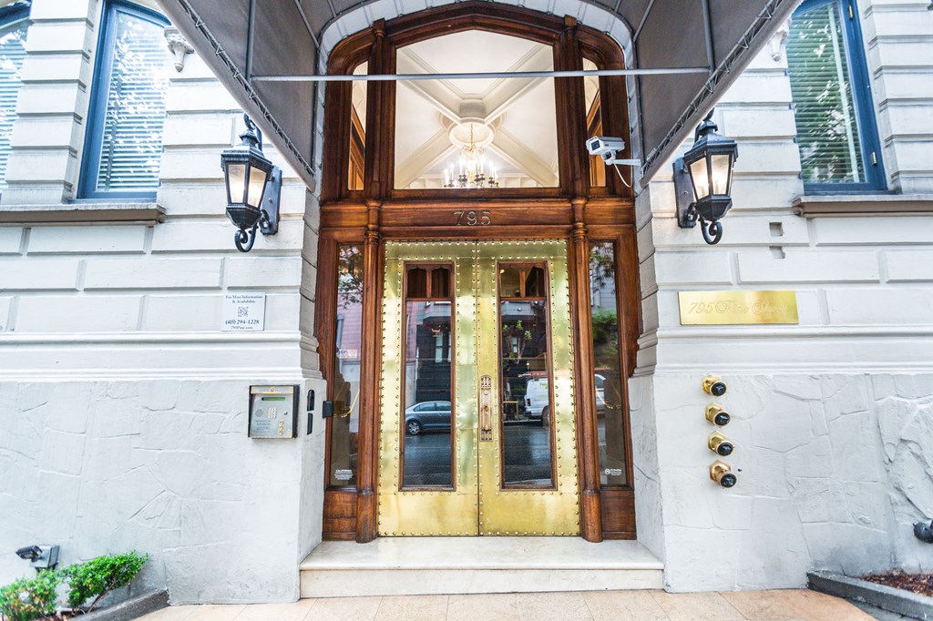 A white building with a brown door and a sign that says "S.S." on it.