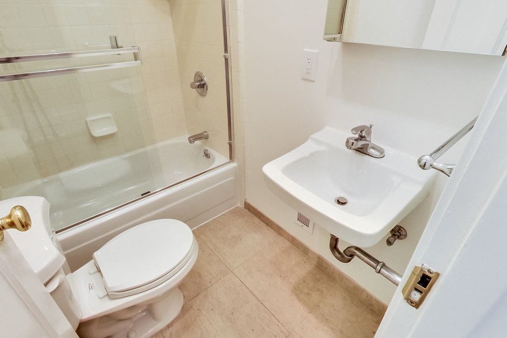 a bathroom with a toilet and a sink and a bath tub