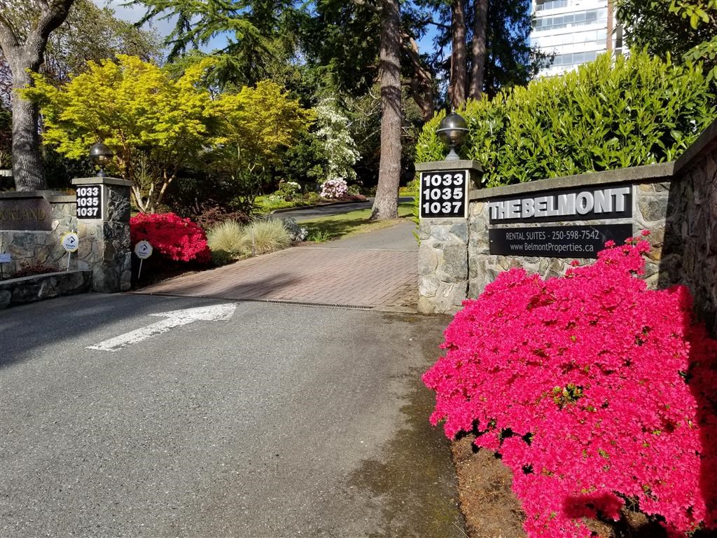 A street sign for Thelmont is on a stone wall.