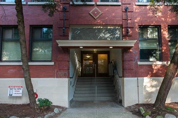 A red building with a white sign on the left side.