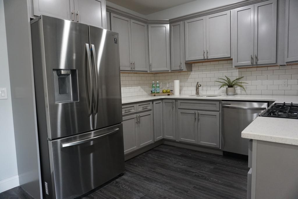 a kitchen with stainless steel appliances and white cabinets