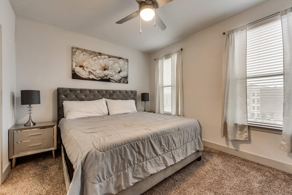 a bedroom with a bed and a ceiling fan