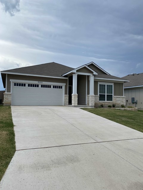 a house with a driveway and a garage door
