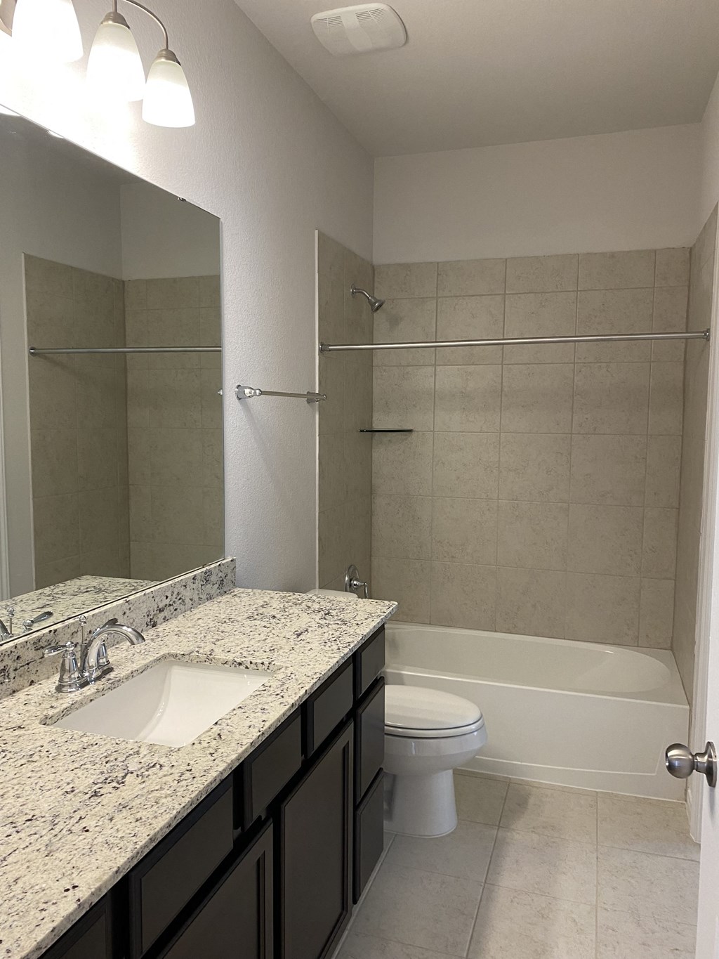 a bathroom with a sink and a toilet and a shower