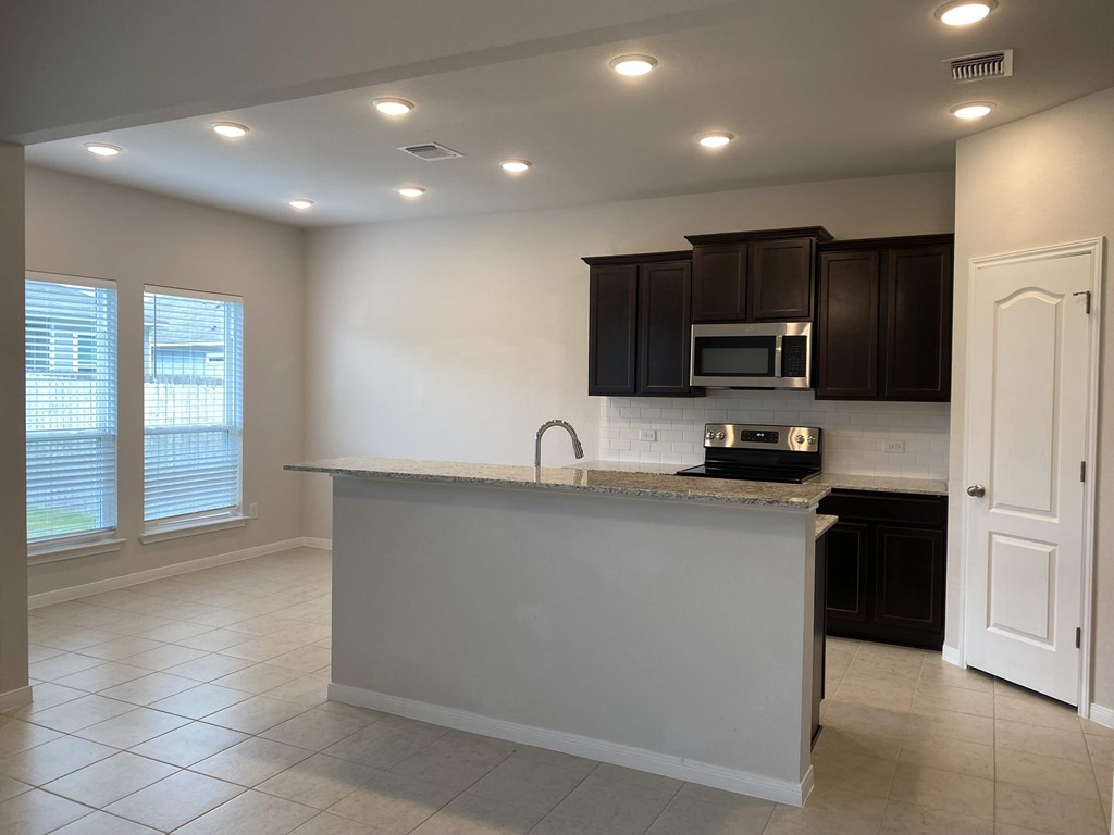 a kitchen with black cabinets and a counter top