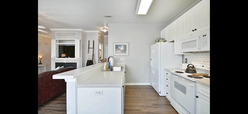 a kitchen with white cabinets and a white counter top