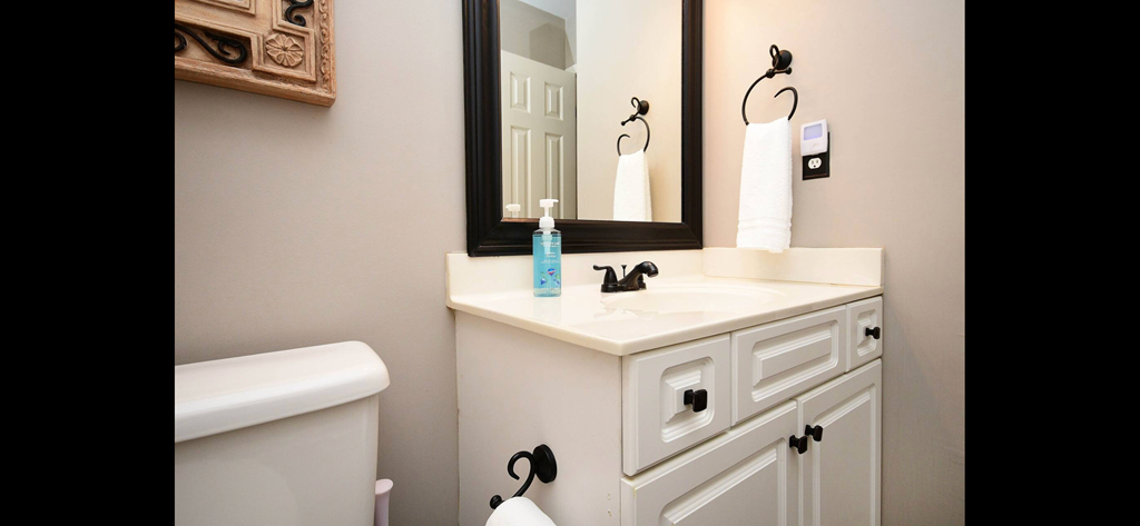 a bathroom with a sink and a mirror and a toilet