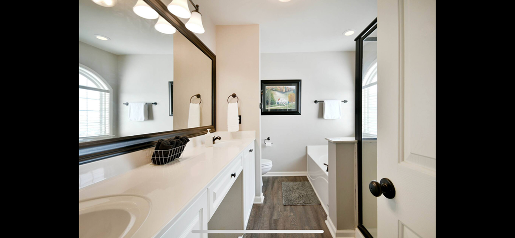 a bathroom with a sink and a mirror and a toilet