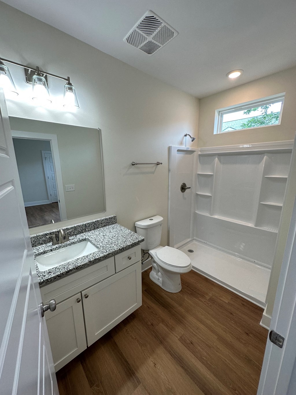 a bathroom with a toilet and a sink and a shower