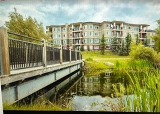 a bridge over a river with buildings in the background