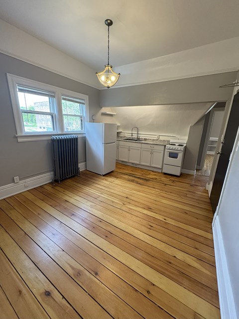 A kitchen with wooden floors and a window.