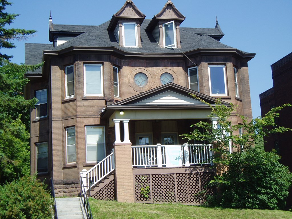 a large brick house with two turrets on top of it