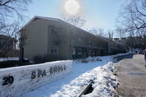 The Spa Kroll building is numbered 20 and has snow on the ground.