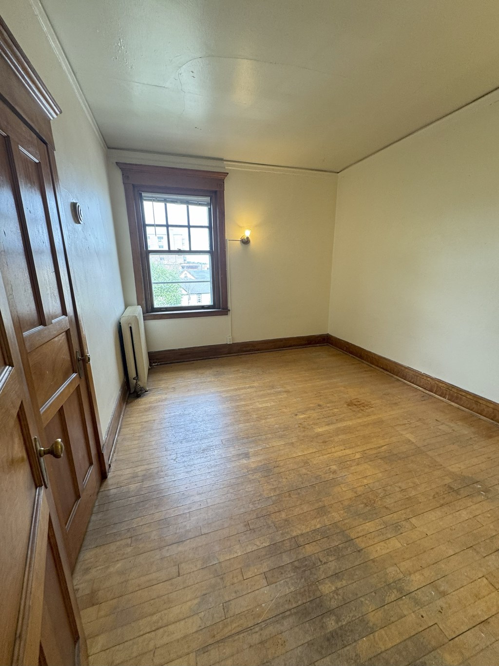 A room with wooden floors and a window.