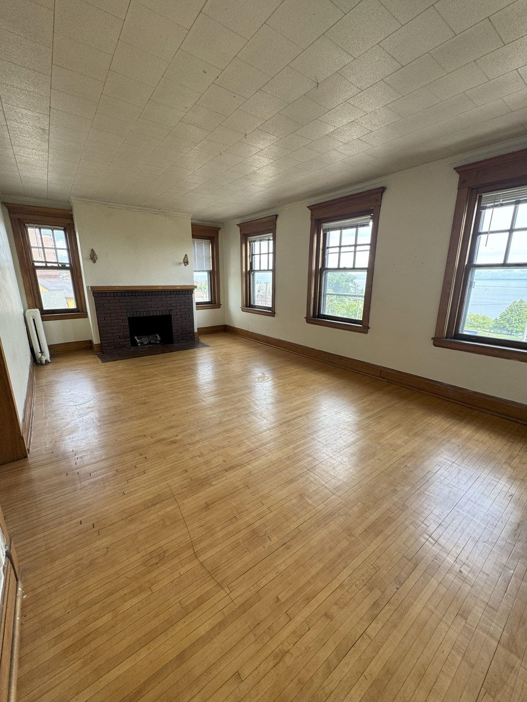 A room with wooden floors and a fireplace.