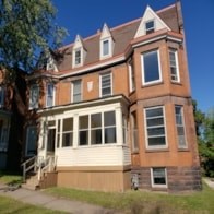 A brown house with a white window.
