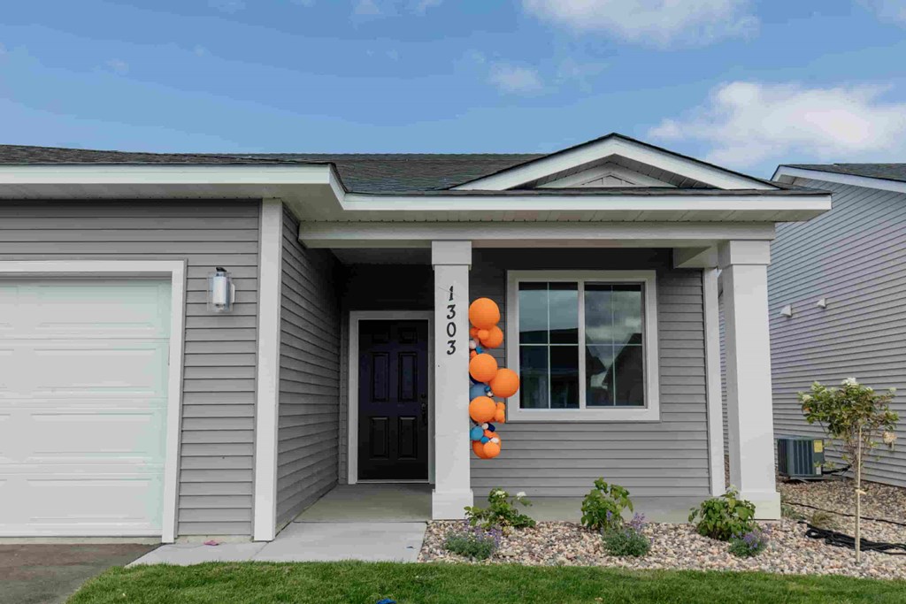 a house with orange balloons on the front door